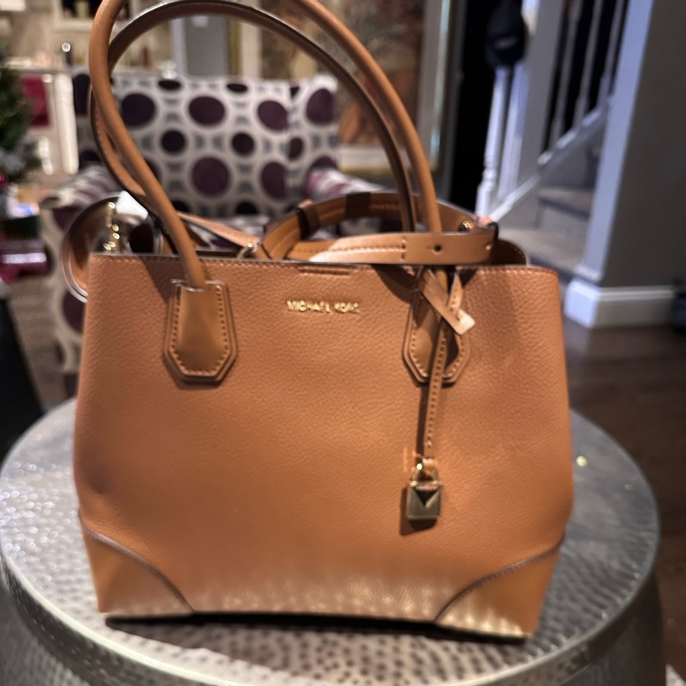 Brand New and never used. Authentic Michael Kors bag.  Has sat in my closet